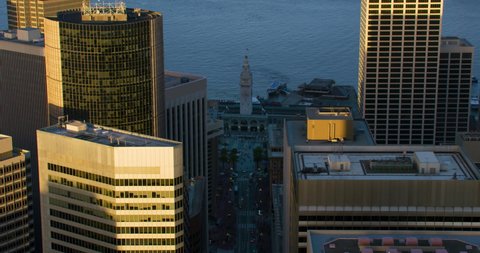 Aerial view of Market street and several skyscrapers. San Francisco Ferry building with its famous clock tower in the background. Financial District. Shot in 8K
