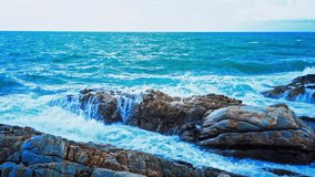 4K. Beautiful tropical blue ocean landscape. Phuket is a tourist destination and famous landmarks in Thailand. Danger sea wave crashing on rock coast with spray and foam.Sea wave rock crush.Video clip