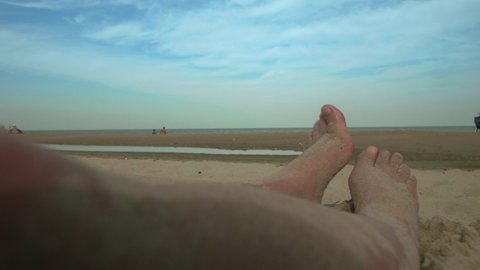 Dewey Beach, Delaware, United States - 09 04 2019: Woman's feet on a sandy beach