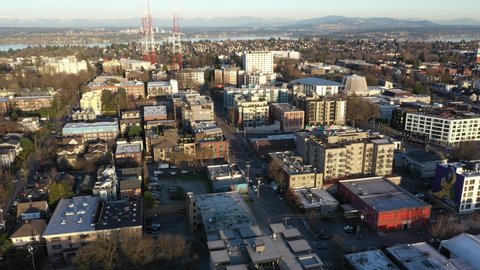 Seattle , WA , United States - 03 31 2021: Cinematic aerial drone trucking shot of Capitol Hill, Miller park, Madison Valley, Stevens, Washington Park, Arboretum, downtown Seattle at sunset in King Co