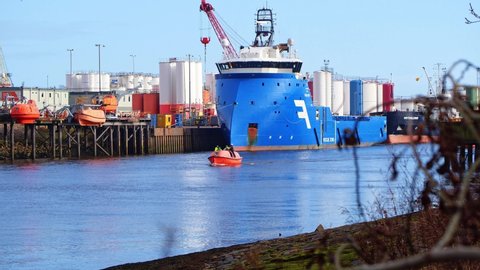 Aberdeen , Aberdeenshire , United Kingdom (UK) - 02 16 2021: Aberdeen Harbour with coastguard lifeboat on training exercise