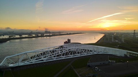 Aerial fly away at sunset from the Maeslandkering, the Dutch storm surge barrier.