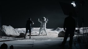 WIDE Behind the scenes, cinematographer shooting viral video for social account on a large Moon landing set. Virtual production with LED screens. Shot with 2x anamorphic lens