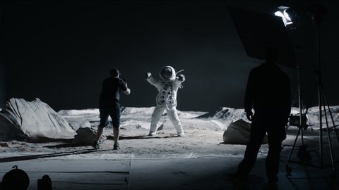 WIDE Behind the scenes, cinematographer shooting viral video for social account on a large Moon landing set. Virtual production with LED screens. Shot with 2x anamorphic lens