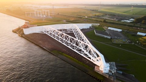 Aerial footage of an arm of the Maesland kering in the Netherlands, while the sun sets.
