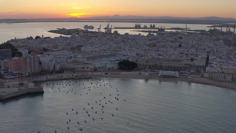 Aerial view over Cadiz lighthouse at sunset, Spain

Beautiful sunset from spain Cadiz City,drone view, 2021
