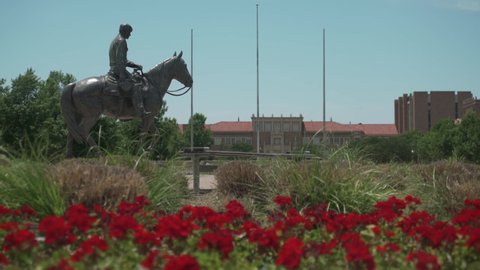 Lubbock, Texas - June 5, 2021: Texas Tech University Will Rogers and Soapsuds statue and campus flowers
