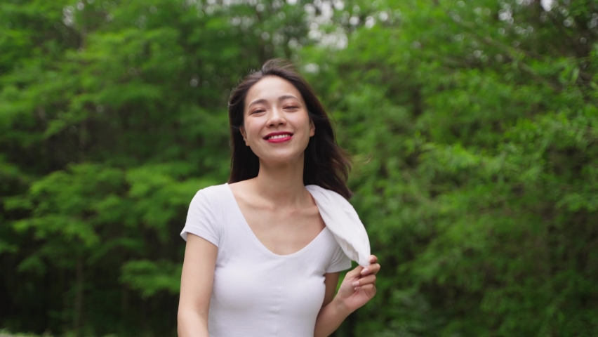 4k slow motion pretty young asian girl walking in the spring park enjoy the nature beautiful day lovely attractive young lady relax outdoor