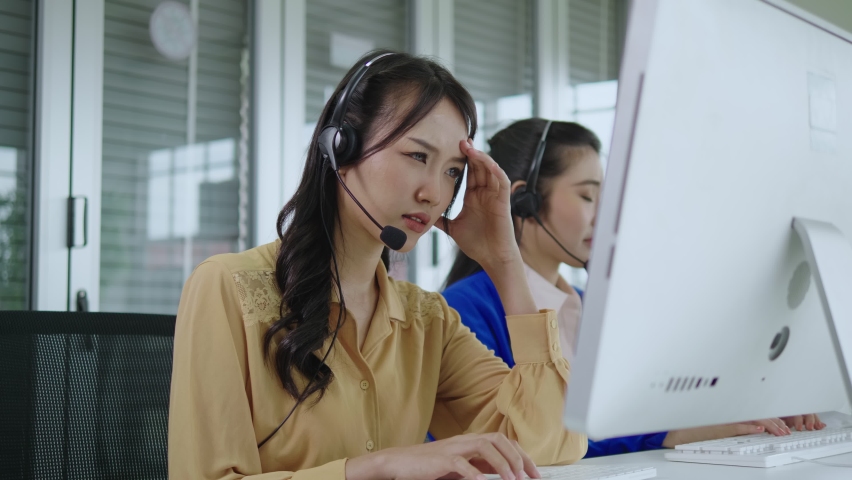 Call center asia woman using computer in office, thinking hard, wondering, stressed, worried about customer problems.telemarketing. Customer support representatives Royalty-Free Stock Footage #1074648806