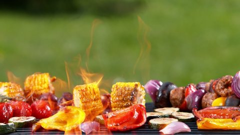 Super slow motion of mix of meat and vegetable on grill grid. Filmed on high speed camera, 1000 fps