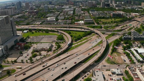 Aerial view of large multilane highway intersection in town. Cars smoothly driving in lanes through multilevel transport construction. Dallas, Texas, US