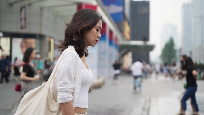 Pretty happy young asian woman walking in the Chengdu urban city street 4k slow motion side view lovely lady enjoy the day street lifestyle | Shutterstock HD Video #1074651080