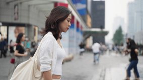 pretty happy young asian woman walking in the Chengdu urban city street 4k slow motion side view lovely lady enjoy the day street lifestyle