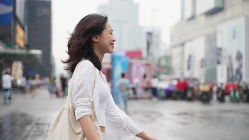 pretty happy young asian woman walking in the Chengdu urban city street 4k slow motion side view lovely lady enjoy the day street lifestyle Royalty-Free Stock Footage #1074651080