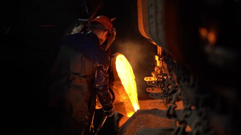 a steelworker pours molten metal from a crucible into molds, the steel industry, a conveyor belt moves 1.