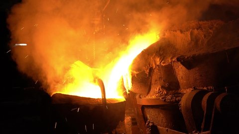 From the blast furnace, the molten liquid metal is poured down the chute into the bowl, the crucible moves through the shop, steel production.