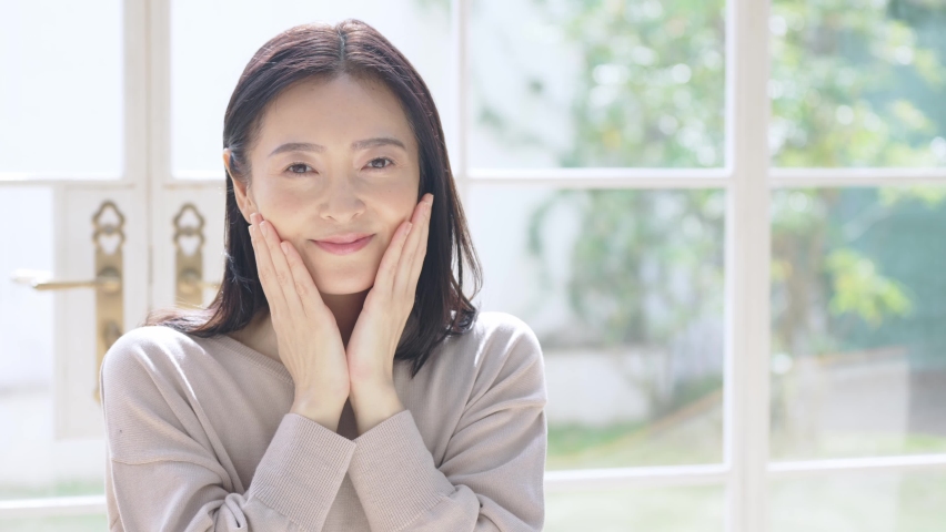 Beauty concept of middle aged asian woman. Skin care. Hair care. Slow motion. Royalty-Free Stock Footage #1074656372