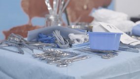 Surgery tools on a table in operating room. Doctors and nurse picking it up.  medical concept.