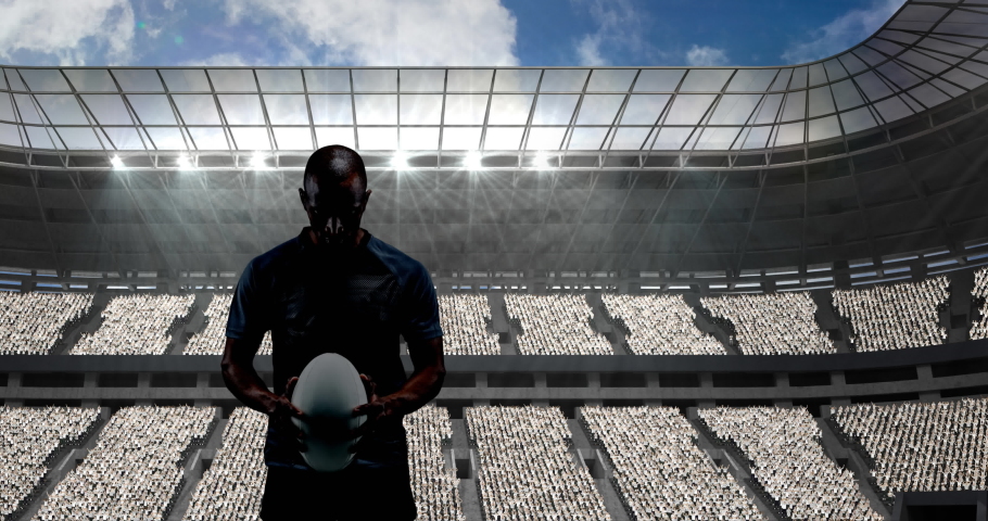 Golden confetti falling over silhouette of male rugby player against sports stadium. sports competition and tournament concept