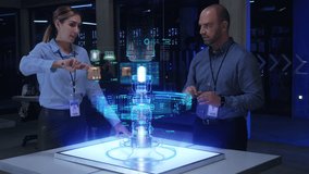 In the Near Future: IT Engineers Work on an Industrial 3D Model Project using Futuristic Table with Holographic Modern Augmented Reality Technology in Modern Research Facility. Advanced Tech Reactor. - Powered by Shutterstock - Get 15% off with code: PIKWIZARD15