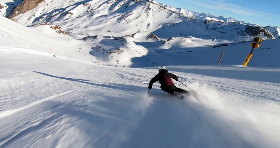 High speed ski turns on a steep ski slope in a glacer ski resort high up in the alps with fresh snow. Panorama skiing with the best mountain landscape is the absolute freedome. Cold winter day skiing. Royalty-Free Stock Footage #1074675071