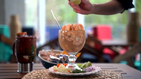 Slow motion lemon splash in shrimp cocktail