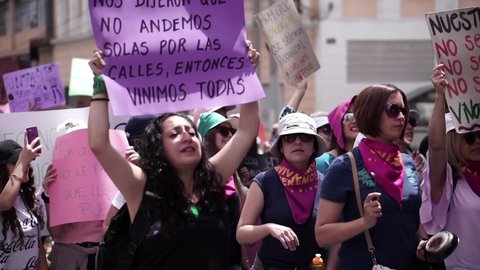 Quito , Quito , Ecuador - 03 08 2020: Women using megaphone and holding signs during International Women's Day