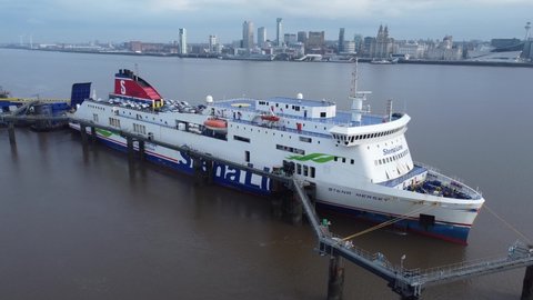 Birkenhead , Liverpool , United Kingdom (UK) - 02 07 2021: Stena Line freight ship vessel loading cargo shipment from Wirral terminal Liverpool aerial left city landscape view