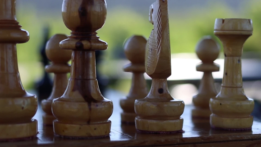 A low flight behind the white side of a chess game.