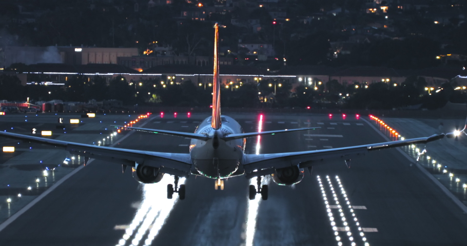 Cinematic travel background, 4K footage of tourism in United State of America after coronavirus pandemic. Tourists arriving at the summer vacation at night airport. Night scene cityscape on background