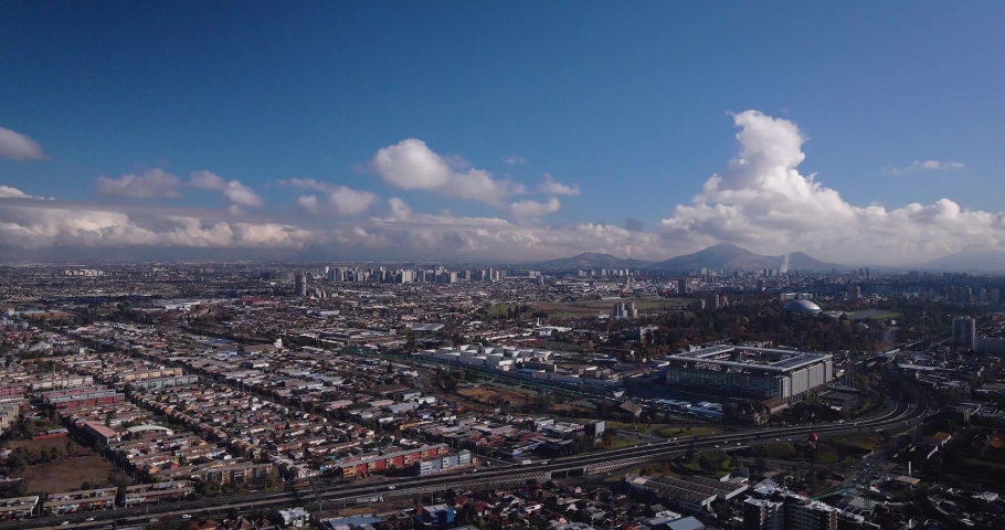 Aerial hyperlapse of santiago de chile with clouds in the background and the panamerican highway