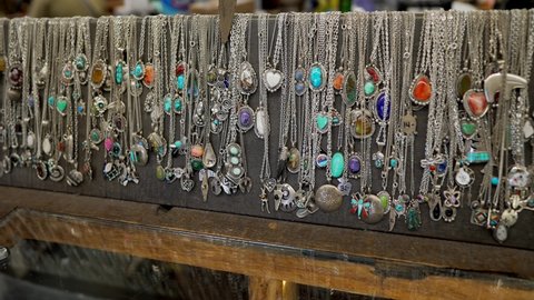 This panning video shows a large collection of silver turquoise southwestern necklaces and jewelry.