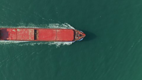 Aerial view of Cargo ship. Large container ship at sea - Aerial top drone view. Moving from left to right. Istanbul, Turkey, Bosporus Strait.