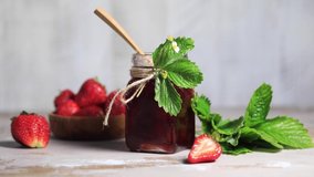 Strawberry jam drips from a wooden spoon into a jar. Fermented berries. Video. - Powered by Shutterstock - Get 15% off with code: PIKWIZARD15