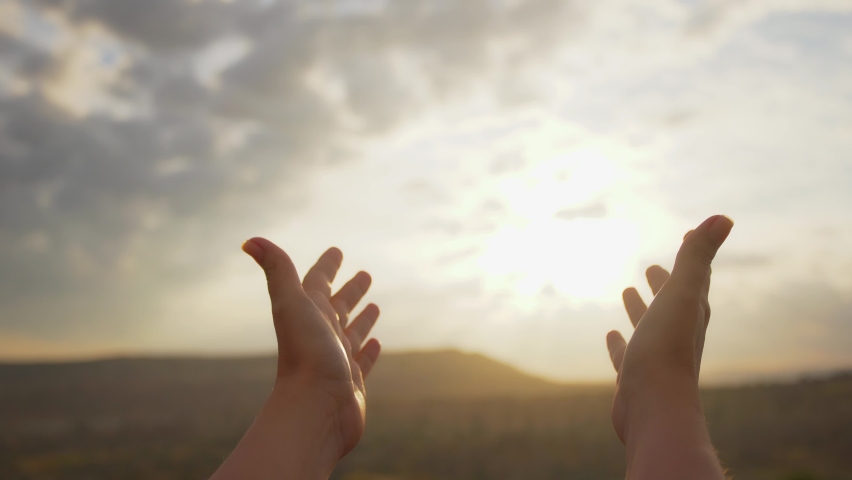 Close-up view 4k stock footage of 2 open hands raised to sun in worship. Woman asks help, advise  or blessing of God. Christian concept video background | Shutterstock HD Video #1074711833