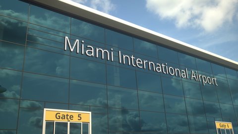 Airliner take off reflecting in the windows with Miami International Airport text