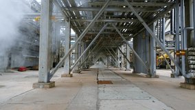 Moving forward under a metal ceiling at an oil refinery. The epic atmosphere of the oil industry. An inside look at getting gasoline - Powered by Shutterstock - Get 15% off with code: PIKWIZARD15