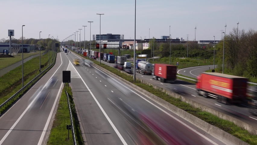 Geel, Antwerp Belgium - June 23 2021: Quick smooth motion video with exposure time of 1 sec of a traffic jam caused by road works on one side of the highway during rush hour.
