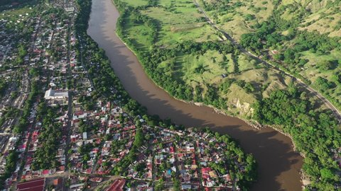 Aerial view of Honda, Colombia and Magdalena River on sunny day, small colonial town in Tolima region, drone shot