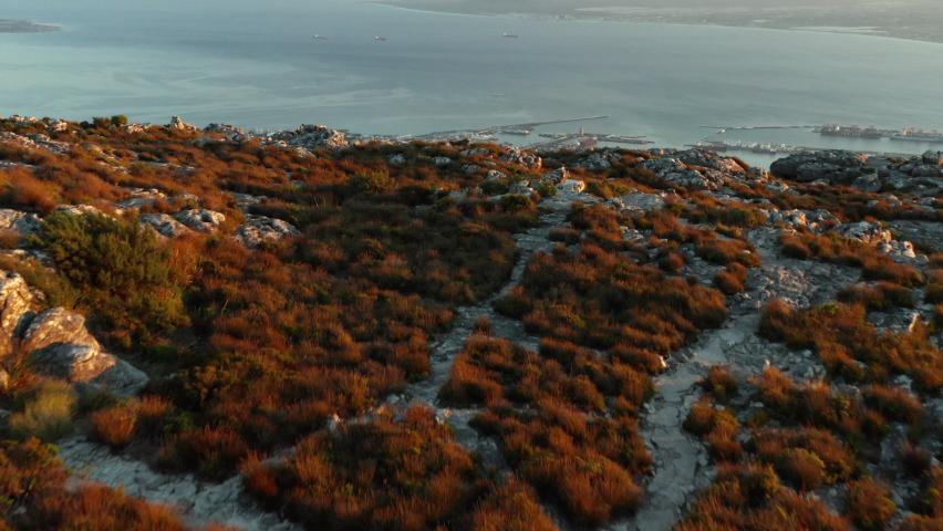 Aerial revealing Sunrise over Cape Town city seen from Table Mountain