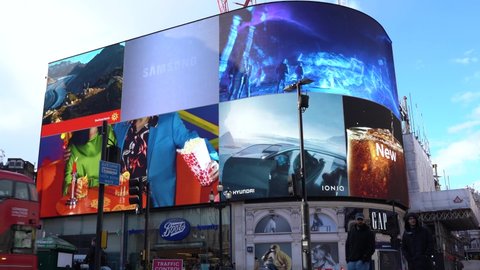 London , London , United Kingdom (UK) - 05 01 2021: Piccadilly Circus video screens with double decker bus
