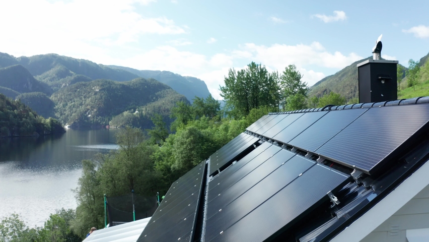 Solar panel installation on private countryside house in western Norway - Forward moving closeup of panels with nature background | Shutterstock HD Video #1074738389