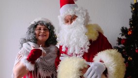 elderly santa claus with his wife congratulates children and adults, shows with hands, concept of christmas, childhood, festive mood, congratulations, good wishes	 - Powered by Shutterstock - Get 15% off with code: PIKWIZARD15