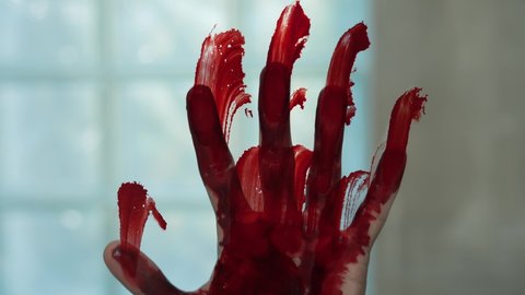 Bloody hand print on a glass
