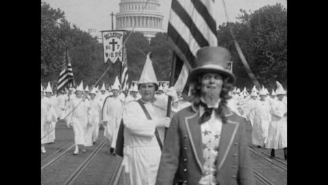 1926 Washington DC. 25,000 Ku Klux Klan Members March down Pennsylvania Avenue in name of White Supremacy. Uncle Sam and the KKK Parade below U.S. Capitol Building. 4K Scan Vintage Archival Film Print