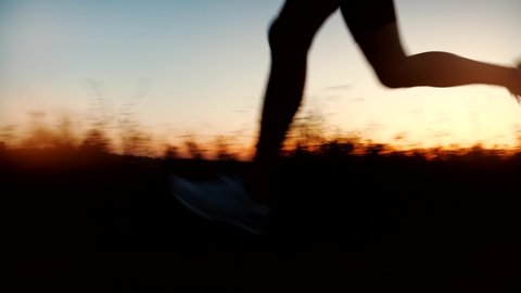 Running Silhouette Sport Training Outdoor Marathon Or Triathlon Exercising.Triathlete Sport Recreation Run Workout On Sunset. Runner Silhouette Jogging At Dusk On Trail.Running Endurance Trail Workout