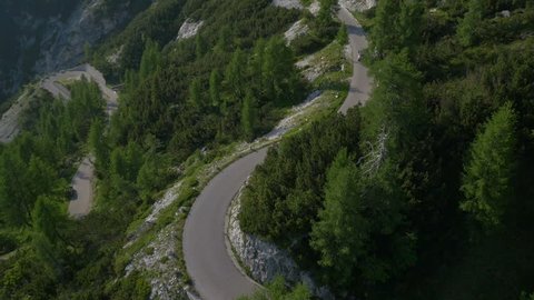Aerial - Car driving over hairpin turns on mountain road