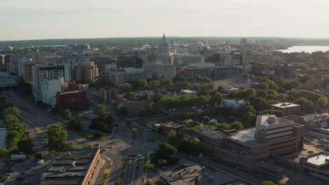 Aerial view above street leading to city downtown in Madison with sunset above Lake Mendota, Wisconsin	