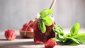 Strawberry jam drips from a wooden spoon into a jar. Fermented berries. Video. - Powered by Shutterstock - Get 15% off with code: PIKWIZARD15