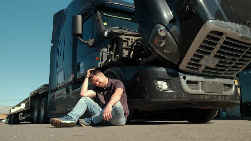 Service, mechanic. The despair the driver is talking by phone about the problem. Logistics. Wide shot Royalty-Free Stock Footage #1074774149